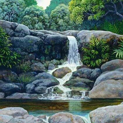 A waterfall over boulders into a pool, from Kokee Waters