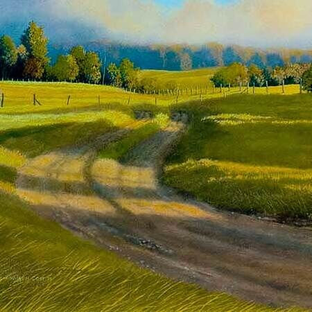 A dirt road curving through green pasture, from Bridle Path