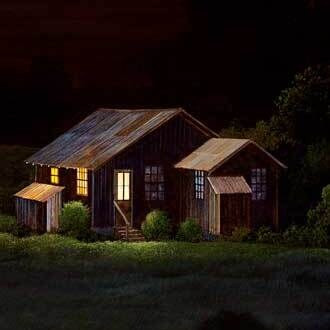 A lit house at night among dark trees, from Midnight Snack